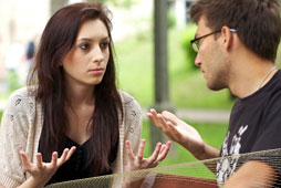 Young couple talking honestly and openingly on a bench